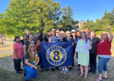 Union members posing with the OPEIU Local 8 banner during Union in the Park Tacoma